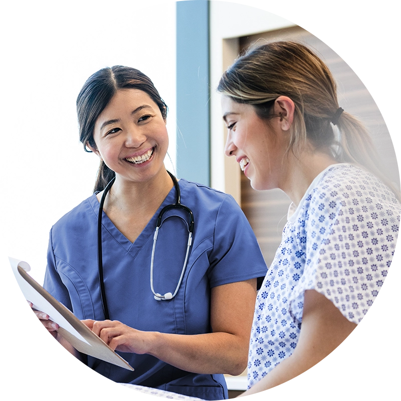 Expecting mother filling out donation form with nurse