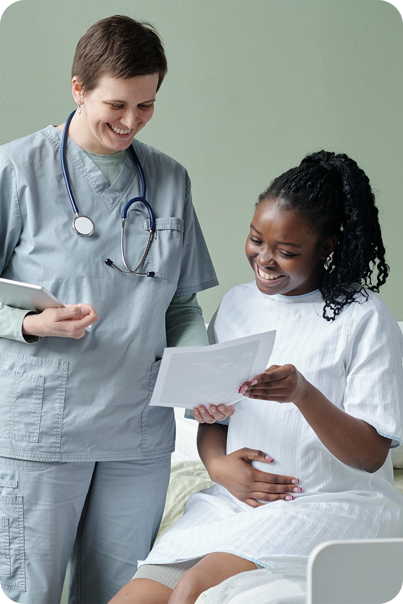 Nurse handing donation form to an expecting mother 